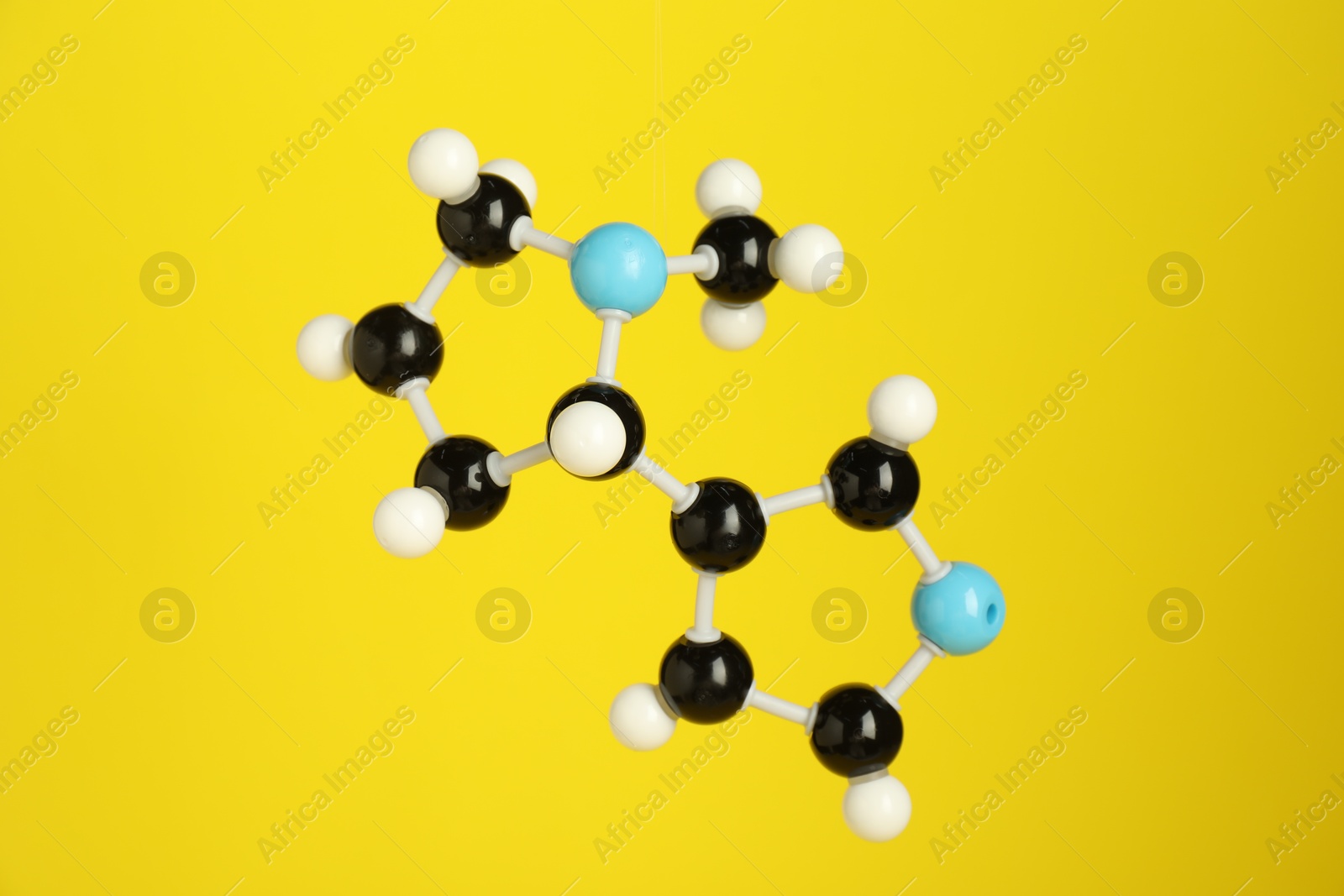 Photo of Chemical model of molecule on yellow background