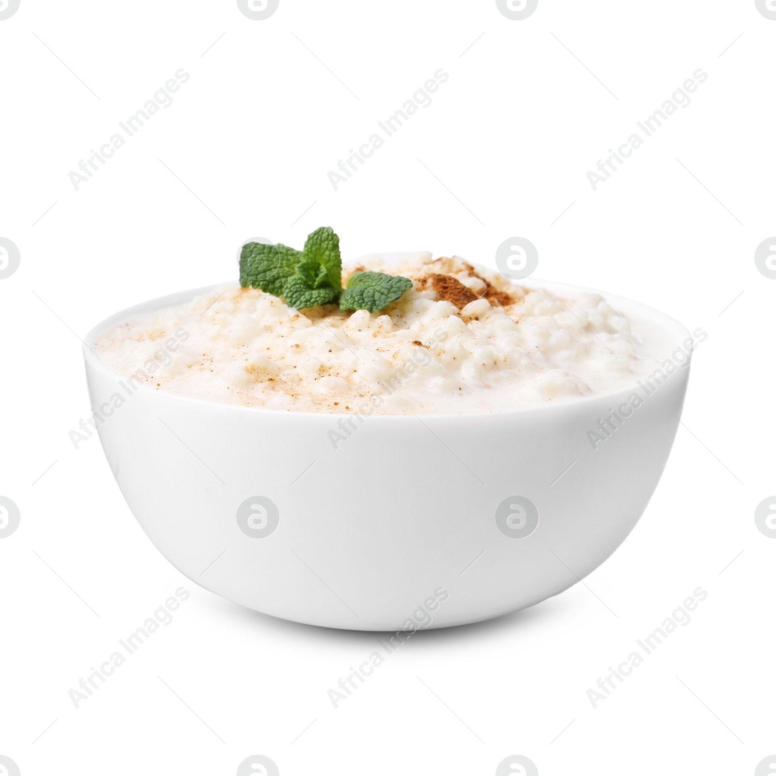 Photo of Tasty rice pudding with cinnamon and mint in bowl isolated on white