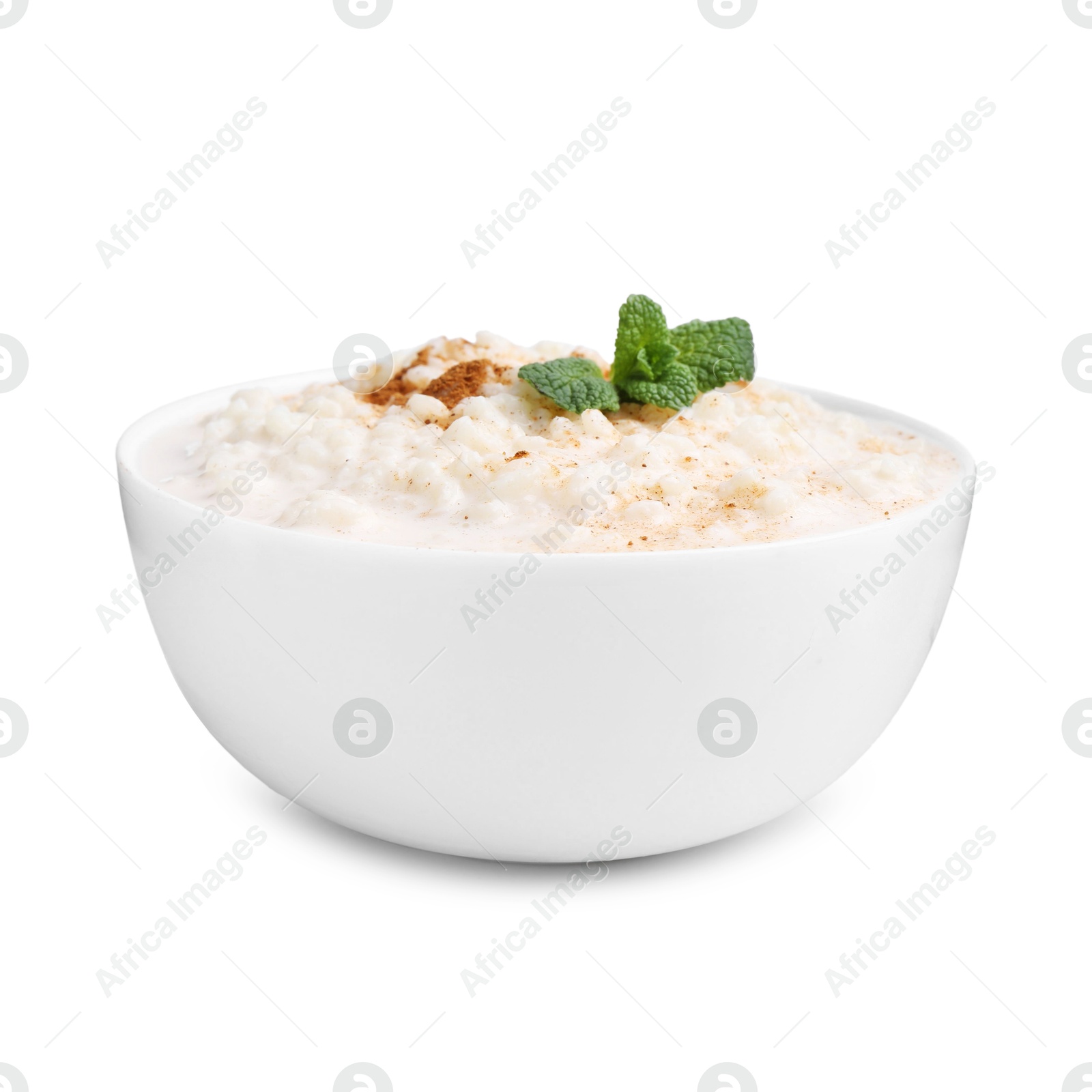 Photo of Tasty rice pudding with cinnamon and mint in bowl isolated on white