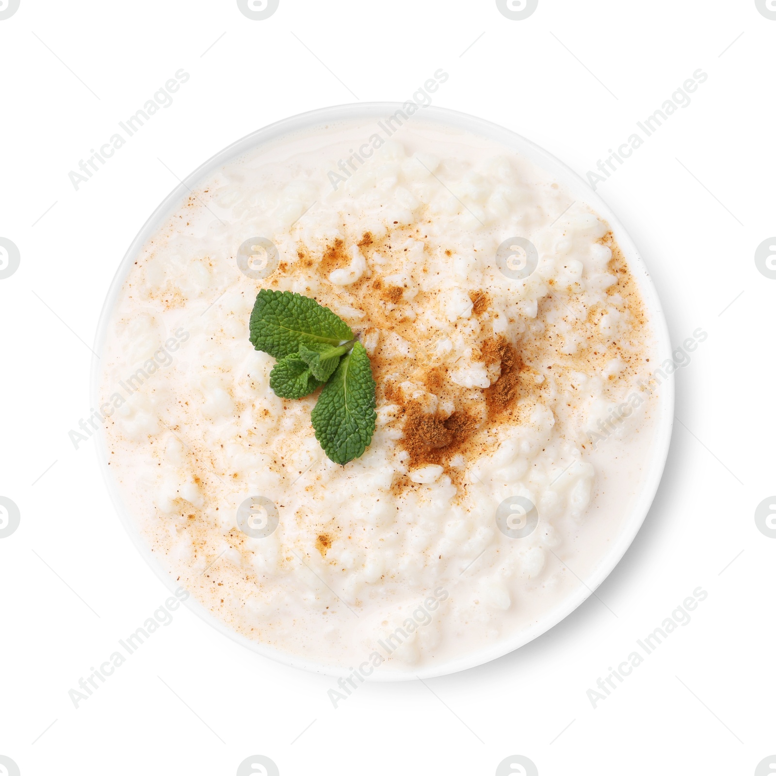 Photo of Tasty rice pudding with cinnamon and mint in bowl isolated on white, top view