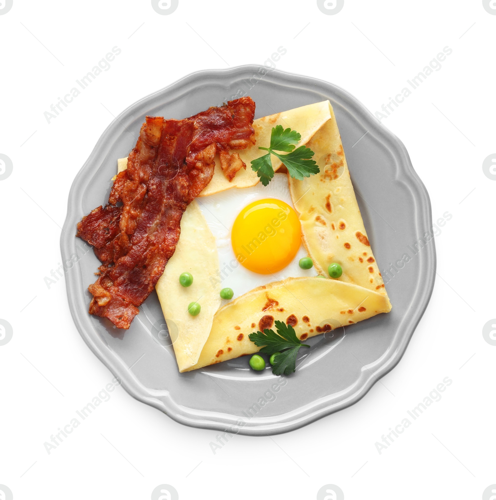 Photo of Delicious crepe with egg, bacon and green peas isolated on white, top view. Breton galette