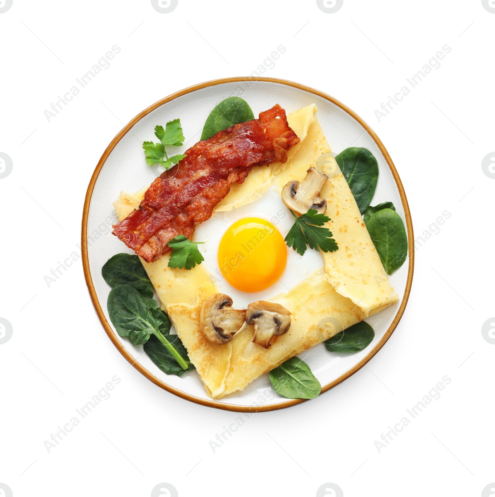 Photo of Delicious crepe with egg, bacon and mushrooms isolated on white, top view. Breton galette