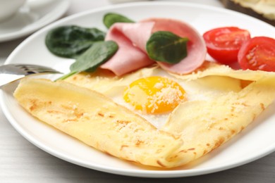 Photo of Delicious crepe with egg, ham and parmesan cheese on table, closeup