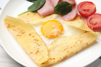 Photo of Delicious crepe with egg, ham and parmesan cheese on table, closeup