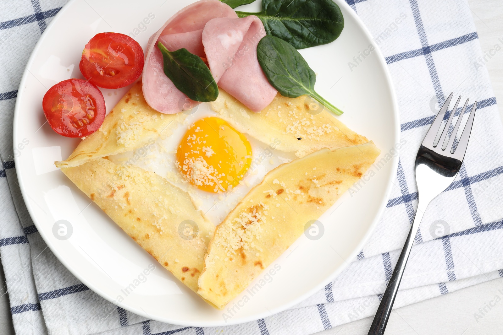 Photo of Delicious crepe with egg, ham and parmesan cheese served on table, flat lay