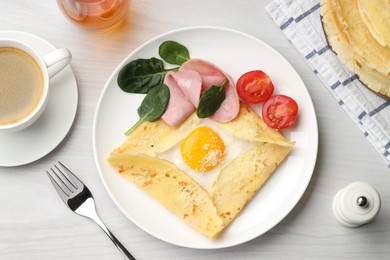 Photo of Delicious crepe with egg, ham and parmesan cheese served on white wooden table, flat lay