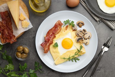 Photo of Delicious crepe bretonne with bacon, mushrooms and arugula served on grey table, flat lay