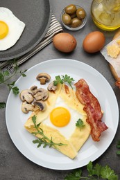 Photo of Delicious crepe bretonne with bacon, mushrooms and arugula served on grey table, flat lay