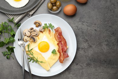 Photo of Delicious crepe bretonne with bacon, mushrooms and arugula served on grey table, flat lay