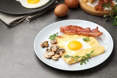 Photo of Delicious crepe bretonne with bacon, mushrooms and arugula on grey table, closeup