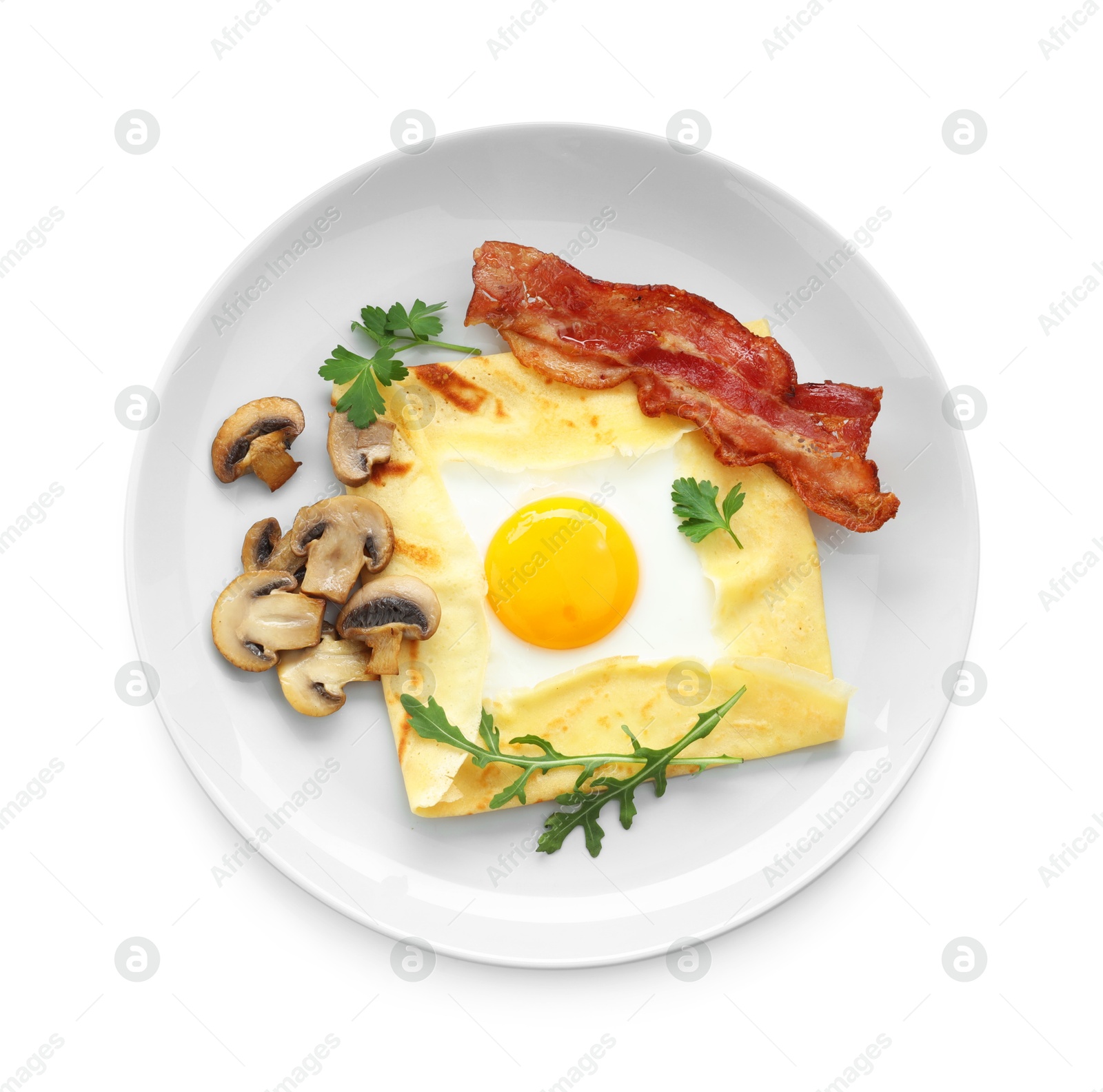 Photo of Delicious crepe bretonne with bacon and arugula isolated on white, top view