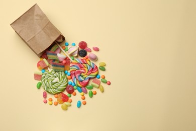 Photo of Different delicious candies and marshmallows on beige background, top view. Space for text