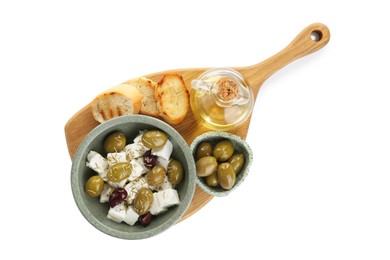 Photo of Marinated olives, feta cheese, bread pieces and oil isolated on white, top view