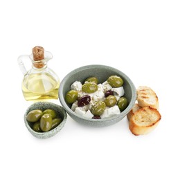 Photo of Marinated olives, feta cheese, bread pieces and oil isolated on white