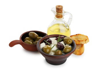 Photo of Marinated olives, feta cheese, bread pieces and oil isolated on white