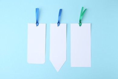 Photo of Paper bookmarks on light blue background, top view