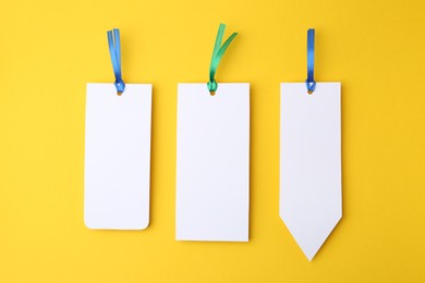 Photo of Paper bookmarks on yellow background, top view