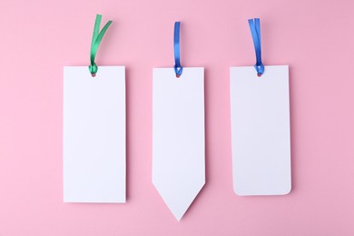 Photo of Paper bookmarks on pink background, top view