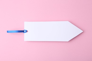 Photo of One paper bookmark on pink background, top view