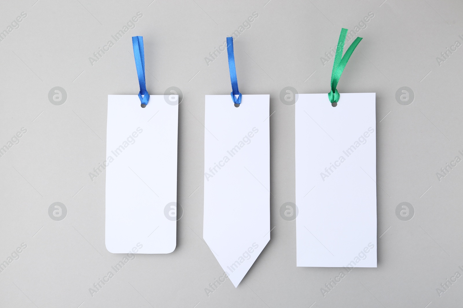 Photo of Paper bookmarks on light grey background, top view