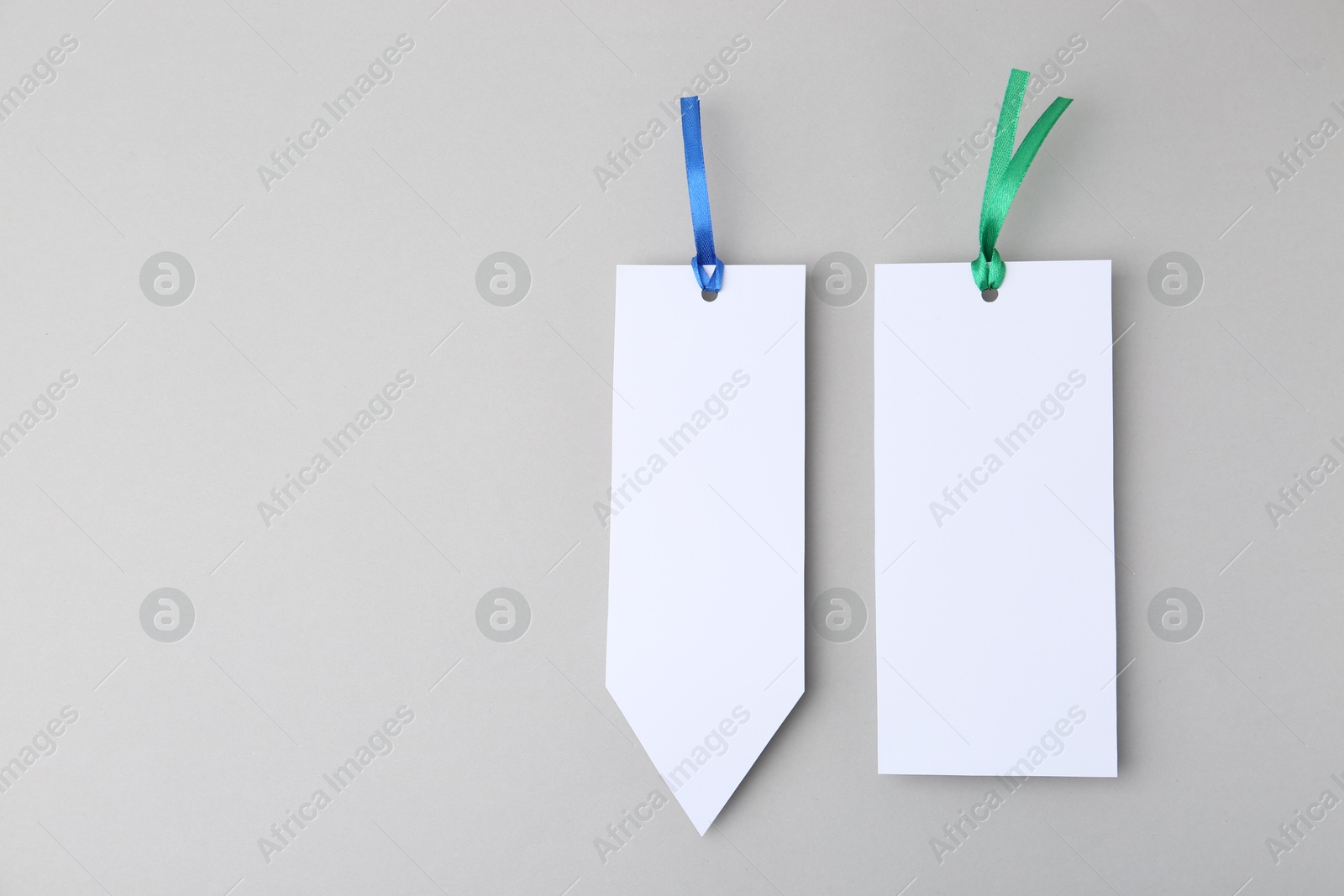 Photo of Paper bookmarks on light grey background, top view. Space for text