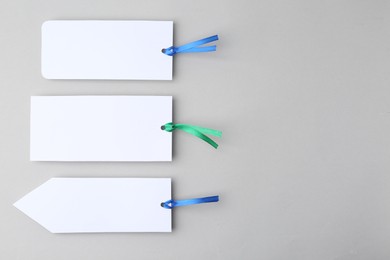 Photo of Paper bookmarks on light grey background, top view. Space for text