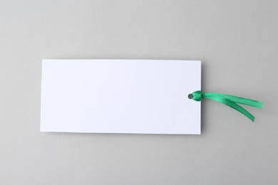 Photo of One paper bookmark on light grey background, top view