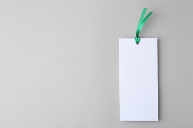 Photo of One paper bookmark on light grey background, top view. Space for text