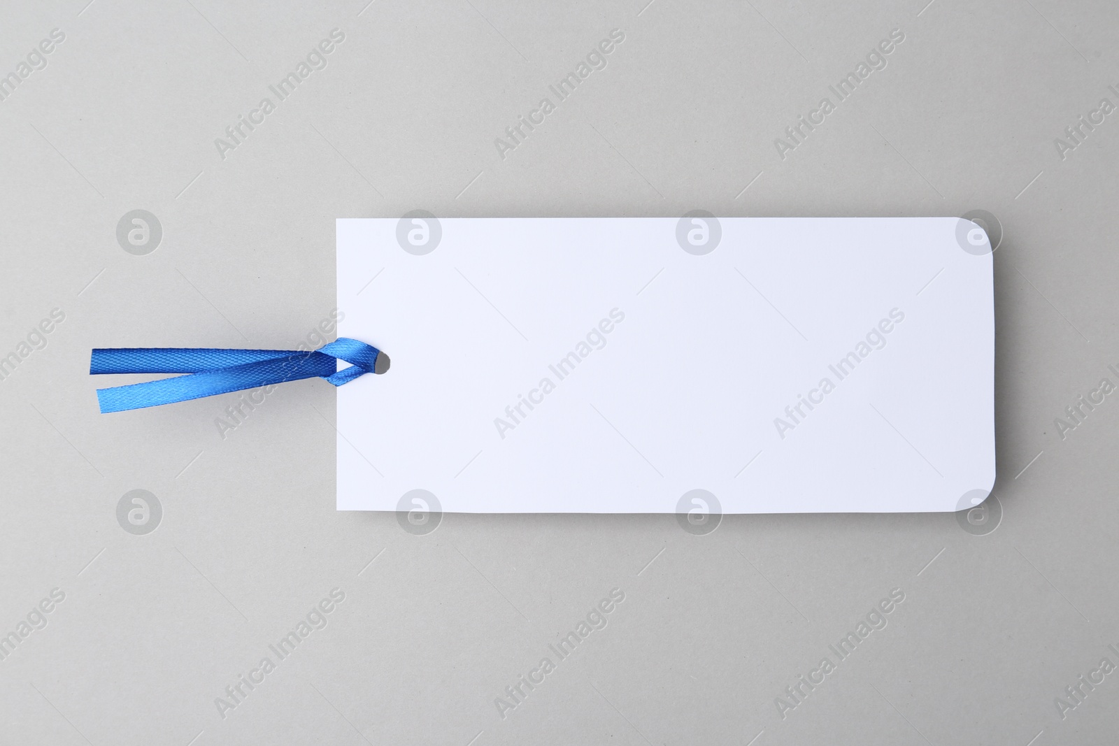 Photo of One paper bookmark on light grey background, top view