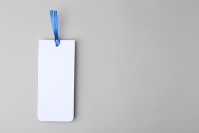 Photo of One paper bookmark on light grey background, top view. Space for text