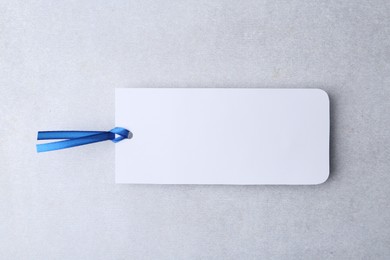 Photo of One paper bookmark on light grey background, top view