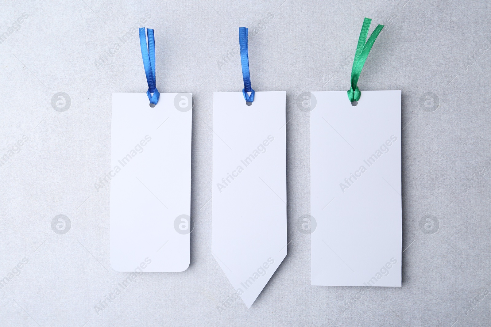 Photo of Paper bookmarks on light grey background, top view