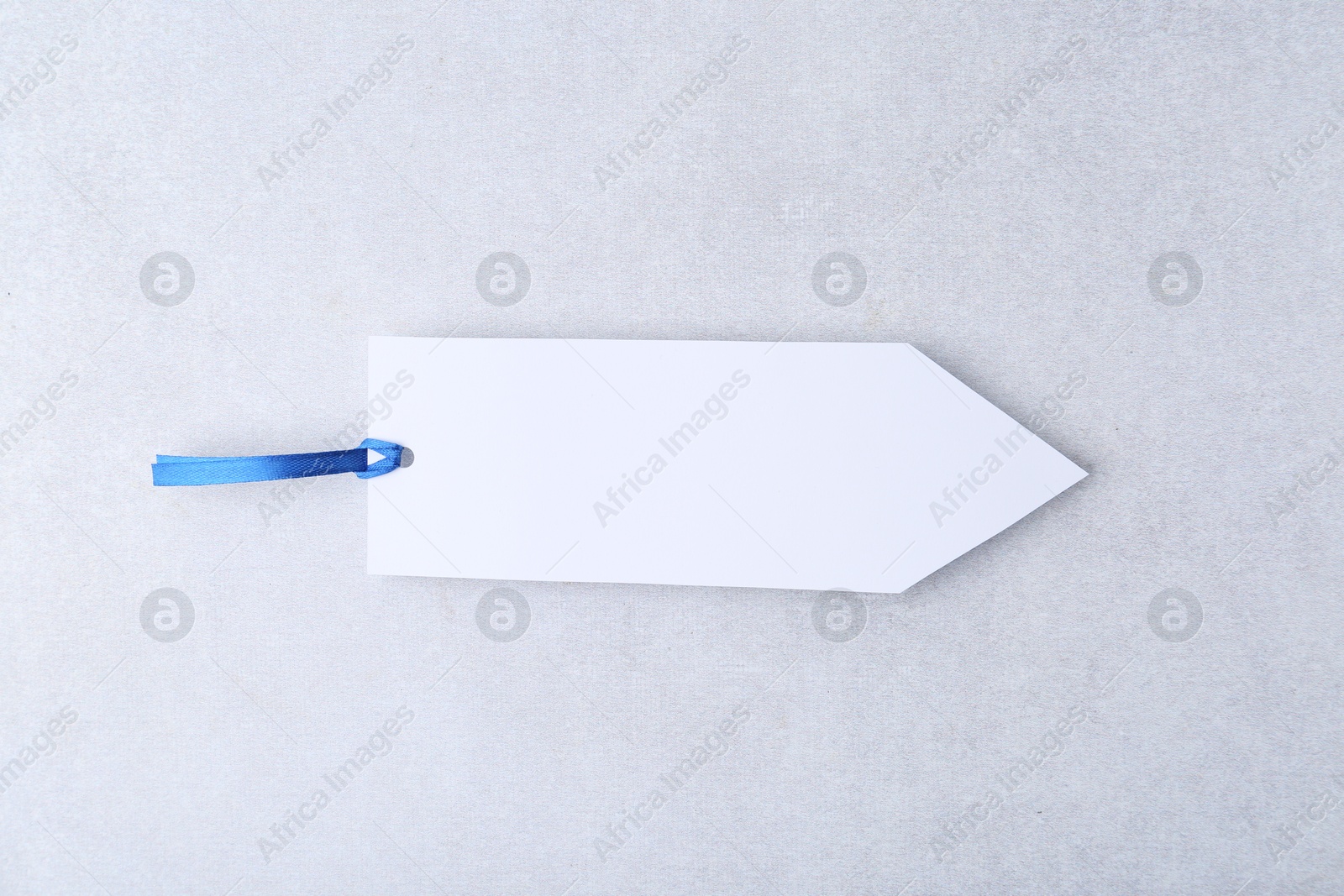 Photo of One paper bookmark on light grey background, top view