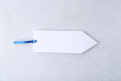 Photo of One paper bookmark on light grey background, top view