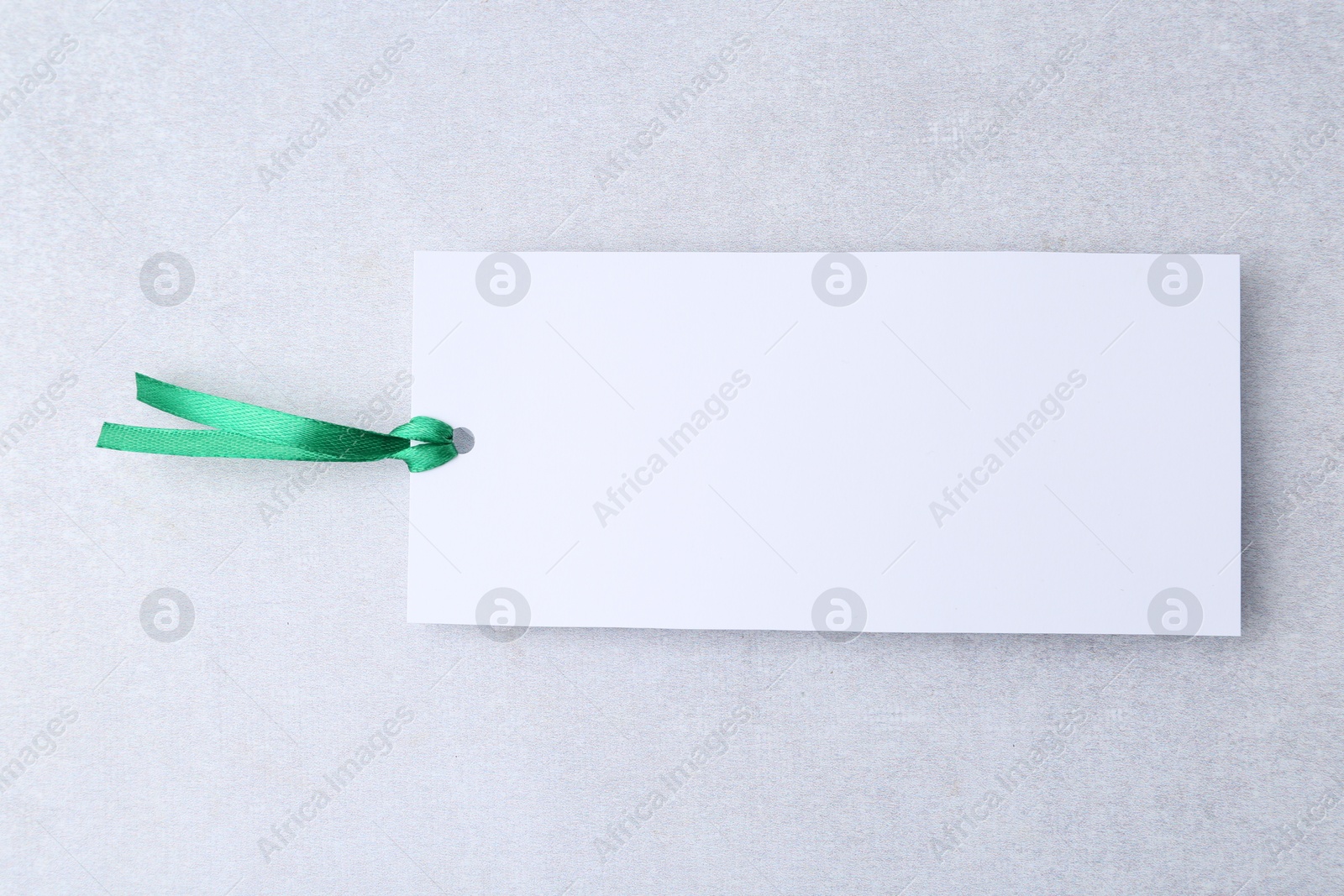 Photo of One paper bookmark on light grey background, top view