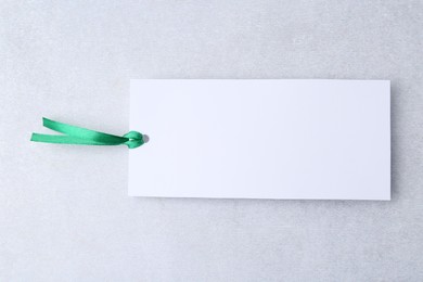 Photo of One paper bookmark on light grey background, top view