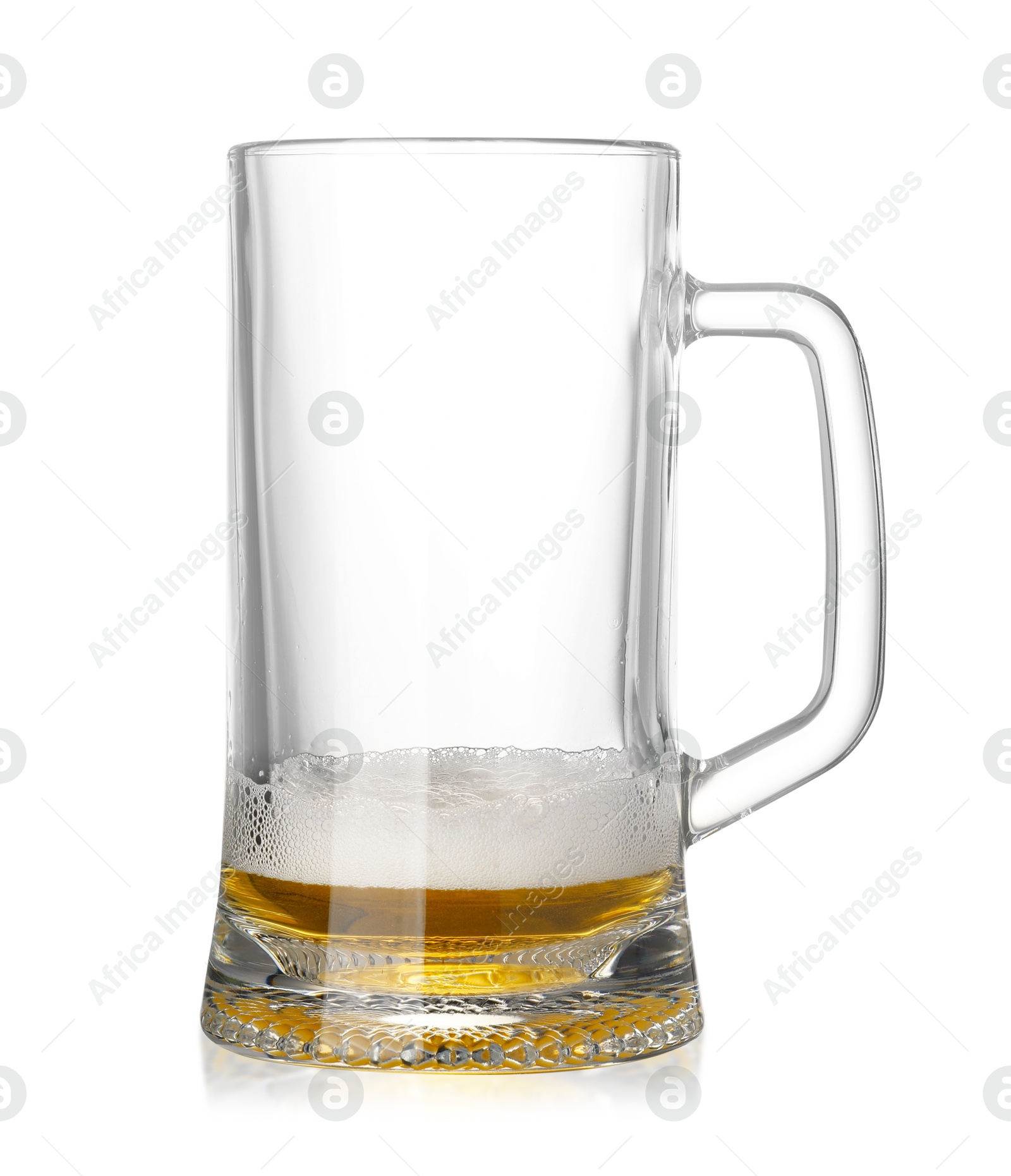 Photo of Almost empty glass mug of beer isolated on white