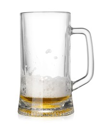 Photo of Almost empty glass mug of beer isolated on white