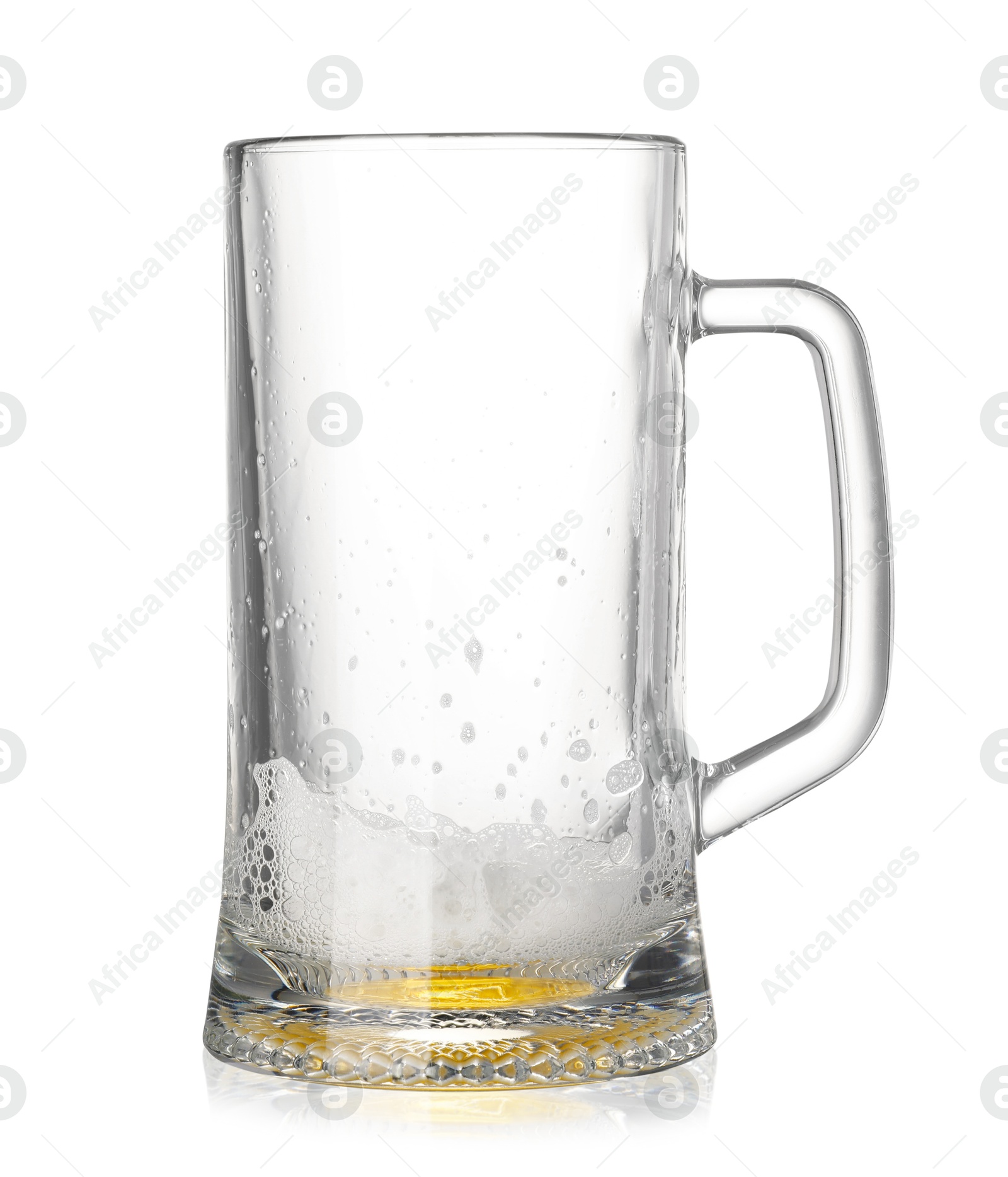 Photo of Almost empty glass mug of beer isolated on white