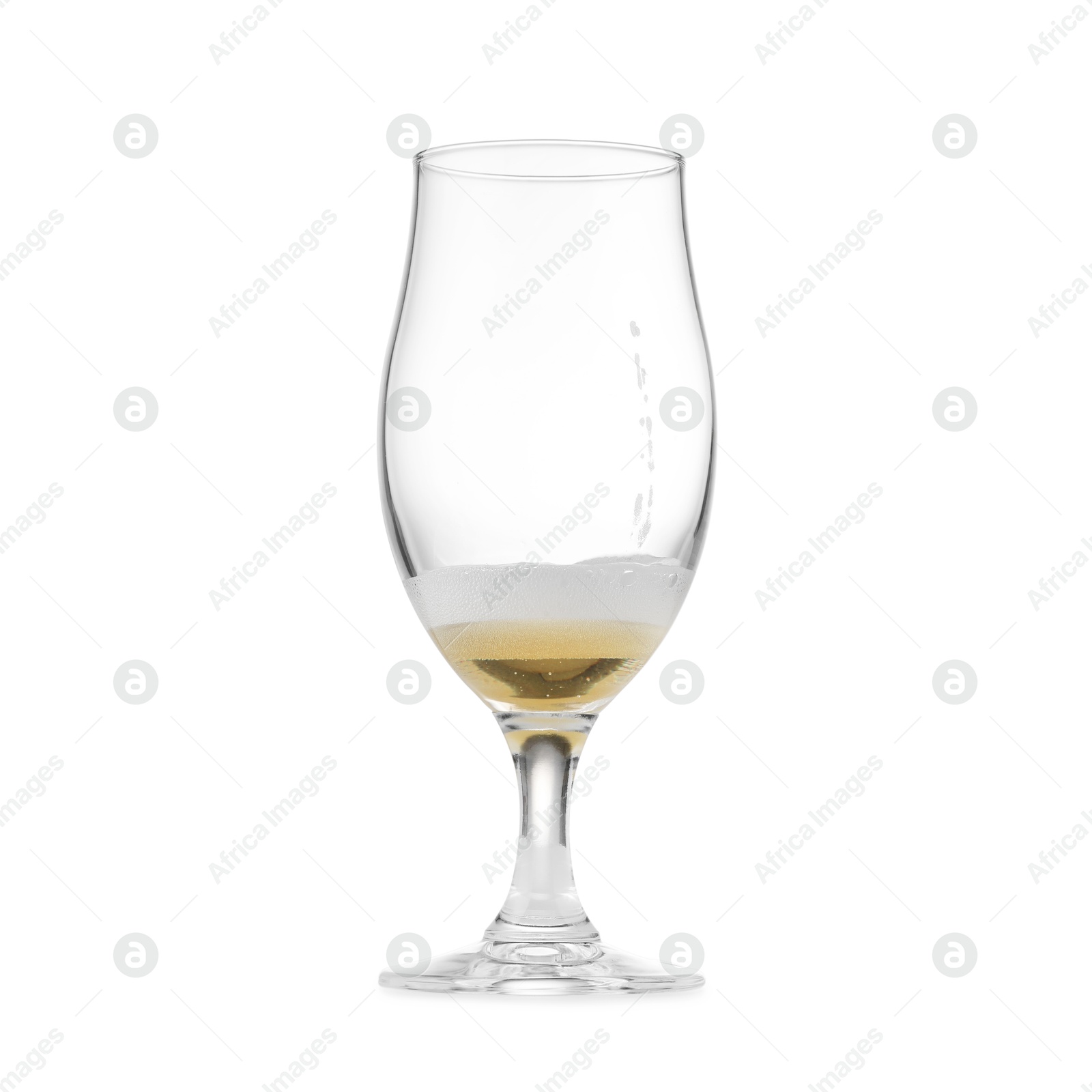 Photo of Almost empty glass of beer isolated on white