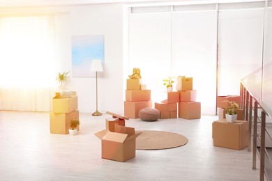 Image of Sunlit room with cardboard boxes. Moving day