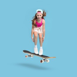 Cute little girl with skateboard in air on light blue background. Performing trick