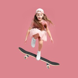 Cute little girl with skateboard in air on pink background. Performing trick