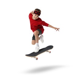 Image of Cute little boy with skateboard in air on white background. Performing trick