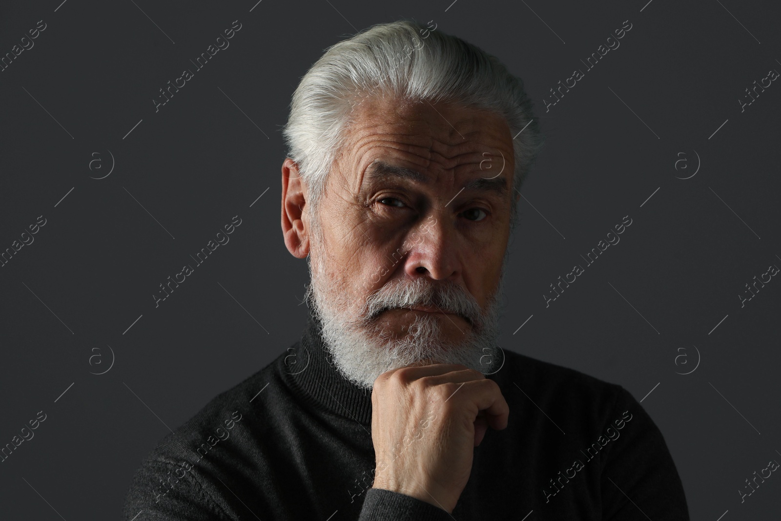 Photo of Portrait of bearded senior man on grey background