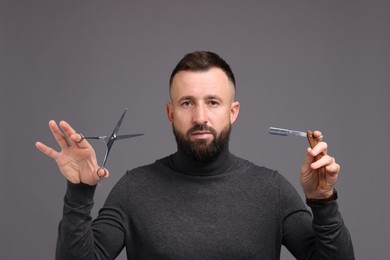 Photo of Bearded man holding blade and scissors on grey background