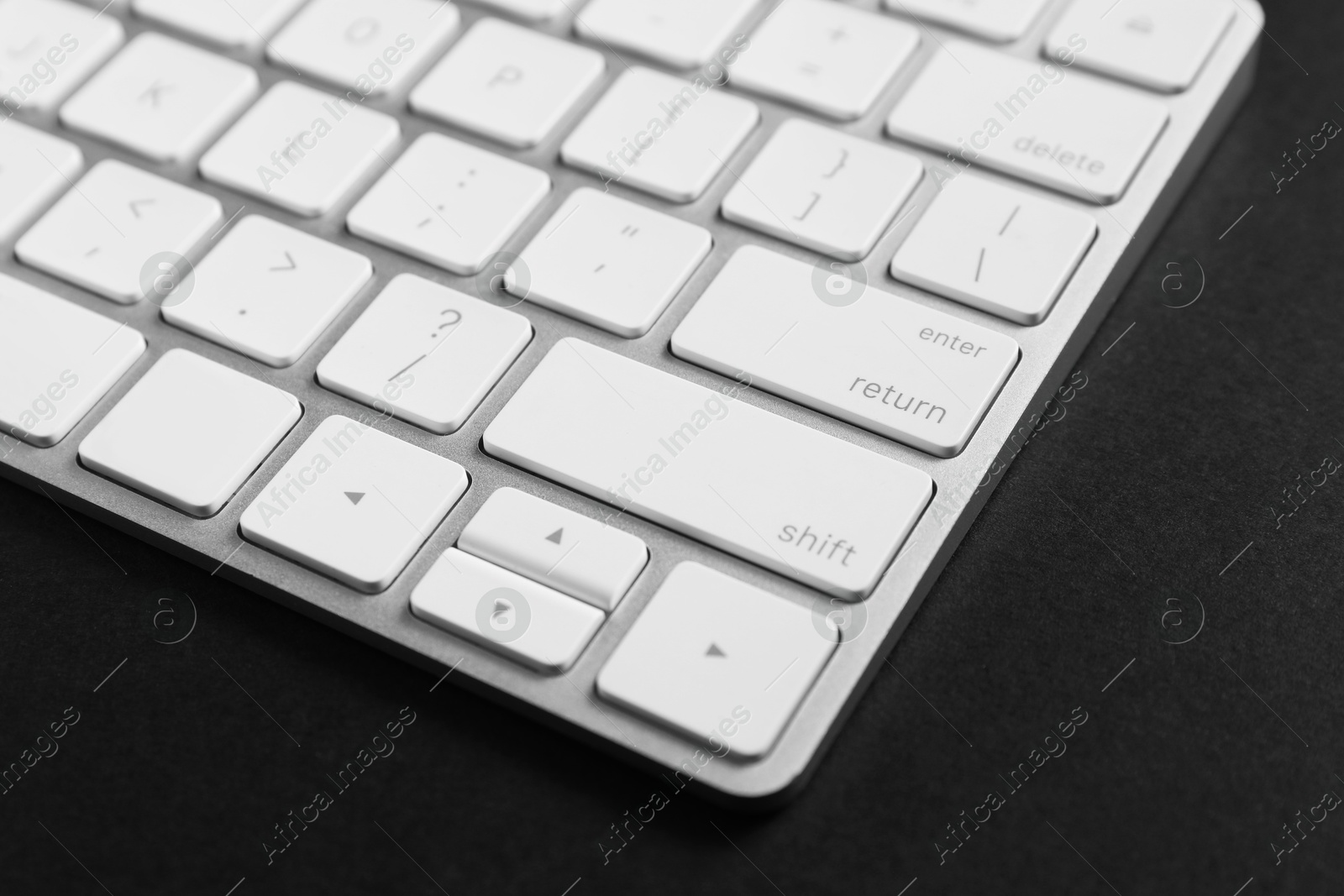 Photo of Technical support concept. Modern keyboard on black background, closeup