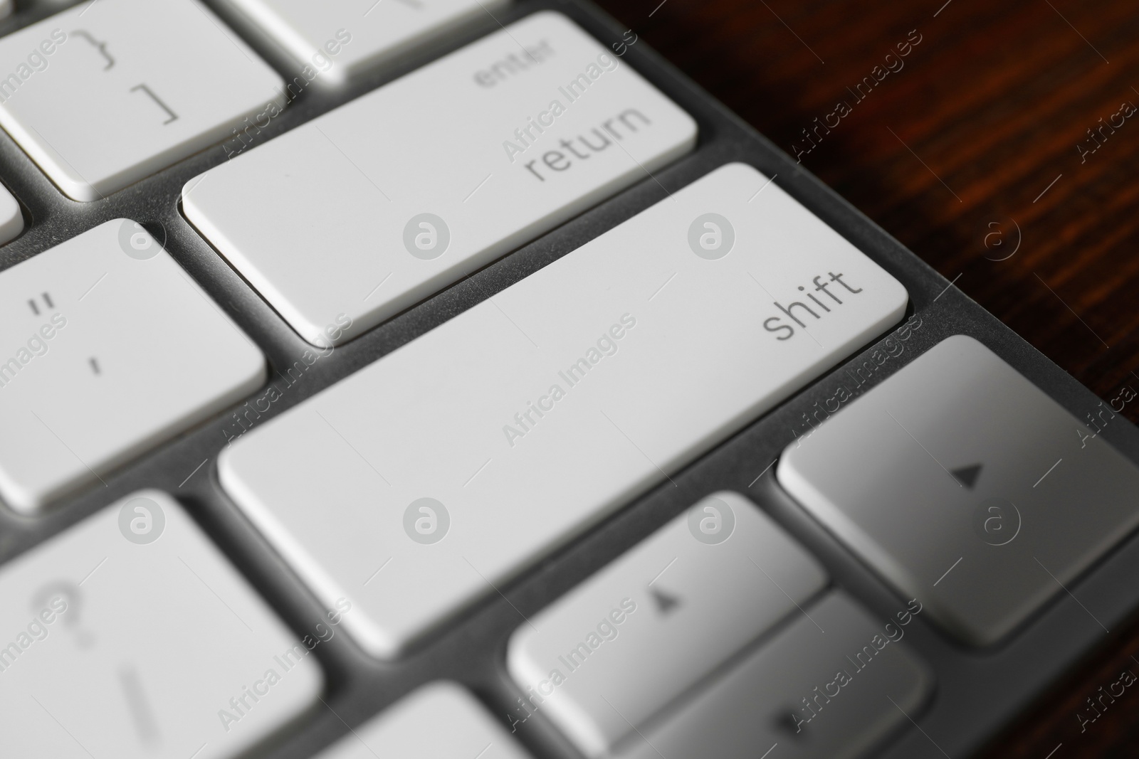 Photo of Technical support concept. Modern keyboard on wooden background, closeup