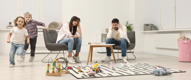 Photo of Hyperactive children playing and their overwhelmed parents at home