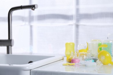 Photo of Clean feeding bottles drying on counter indoors